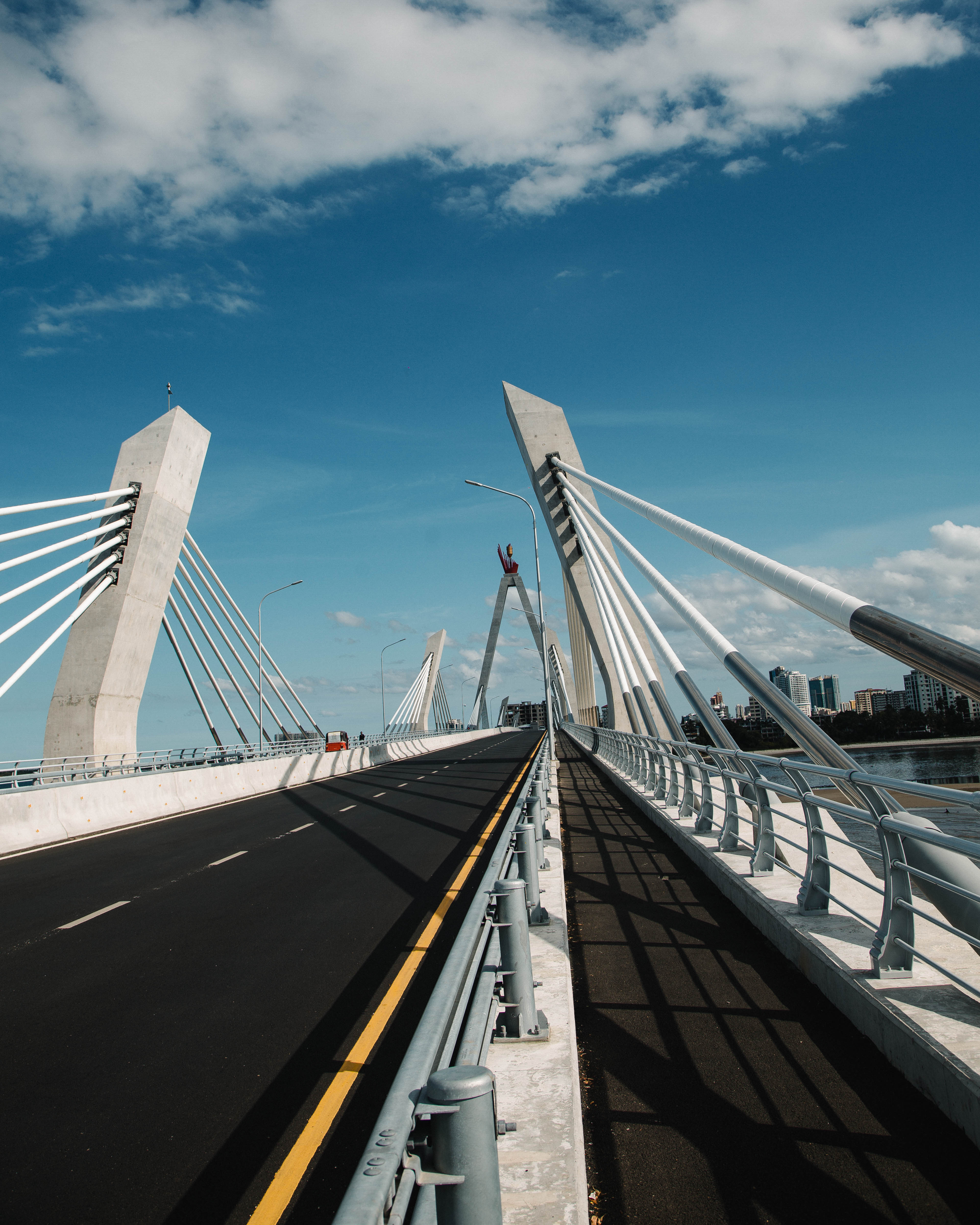 A modern cable-stayed bridge with a clear blue sky in the background.